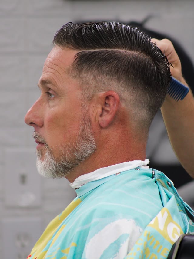 Finished slicked-back haircut with clean faded sides